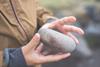 person-holding-a-rock
