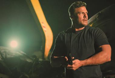 reacher-in-a-dark-shit-holding-a-pistol-at-the-ready-in-a-dark-salvage-yard-2