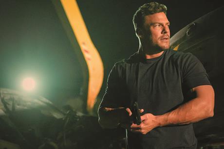 reacher-in-a-dark-shit-holding-a-pistol-at-the-ready-in-a-dark-salvage-yard-2