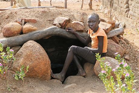 Child at bomb shelter, Nuba Mountains, Sudan., Nuba Mountains, Sudan.