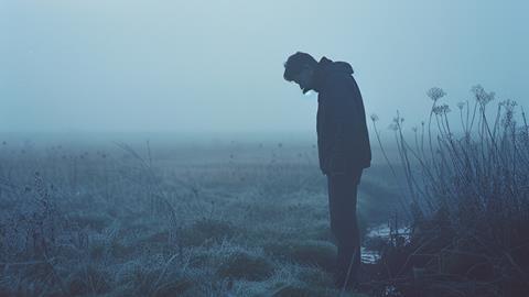 Solitary Figure in Frosty Landscape