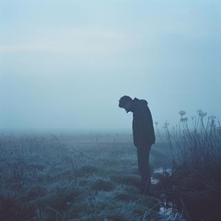 Solitary Figure in Frosty Landscape