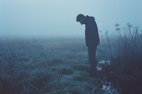 Solitary Figure in Frosty Landscape