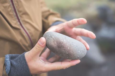 person-holding-a-rock