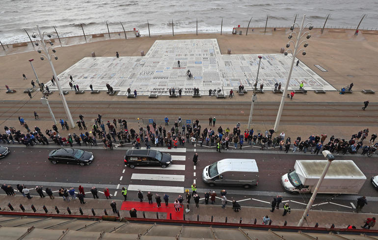 The funeral cortege of entertainer Bobby Ball passes the Comedy Carpet in front of the Blackpool Tower on its way to Carleton Crematorium in Blackpool.
